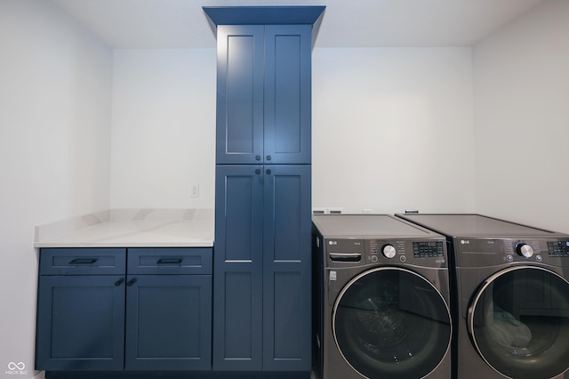 laundry area featuring cabinets and washer and clothes dryer