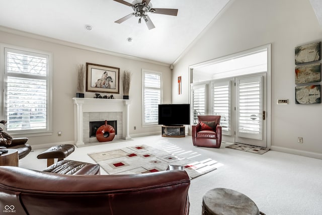 carpeted living room with ceiling fan, lofted ceiling, a tile fireplace, and a wealth of natural light