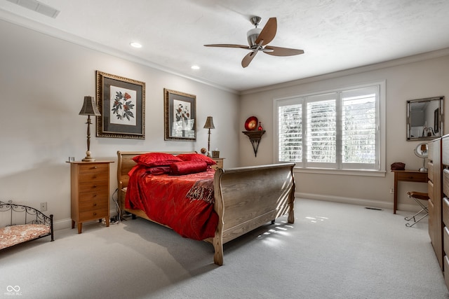 carpeted bedroom featuring ornamental molding and ceiling fan