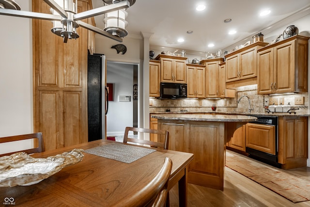 kitchen with a center island, dark stone countertops, light wood-type flooring, and decorative backsplash