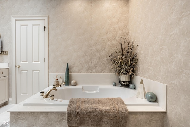 bathroom with vanity and tiled tub