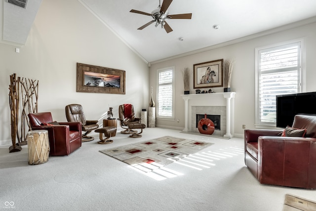 sitting room with a tiled fireplace, crown molding, carpet, and high vaulted ceiling