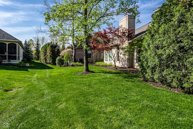 view of yard featuring a sunroom