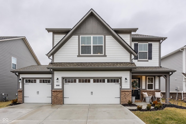 view of front facade with a garage, a front lawn, and covered porch