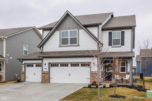 craftsman-style house featuring a garage and a front yard