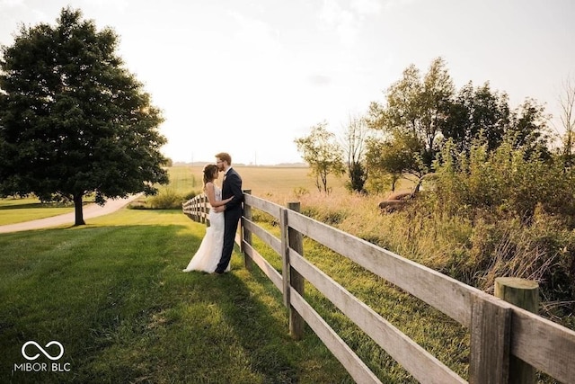 view of property's community with a yard and a rural view