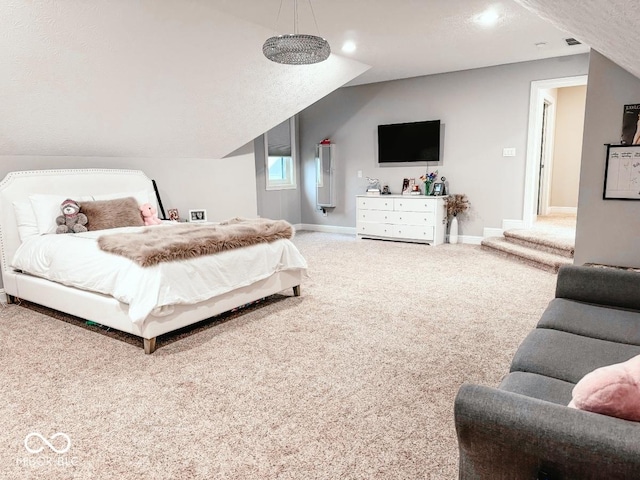 carpeted bedroom featuring vaulted ceiling and a textured ceiling