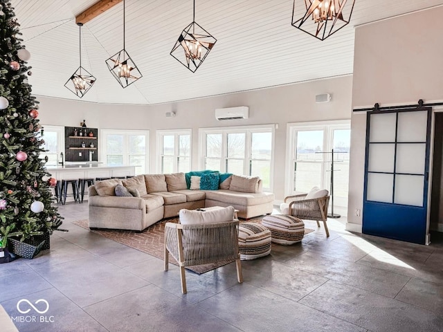 living room with high vaulted ceiling, a wall unit AC, beam ceiling, a barn door, and an inviting chandelier