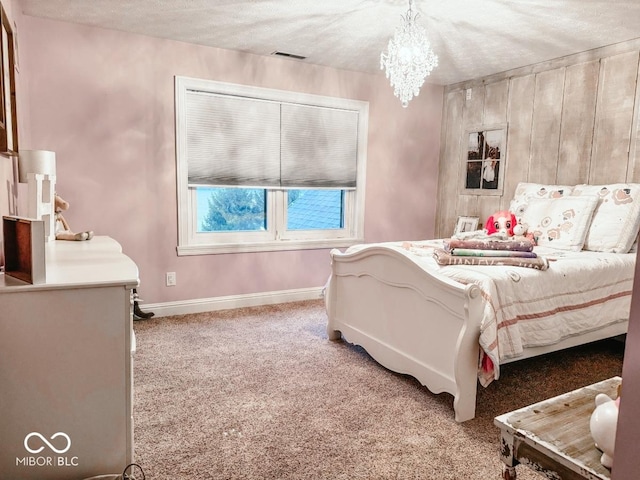 bedroom featuring carpet, a notable chandelier, and a textured ceiling