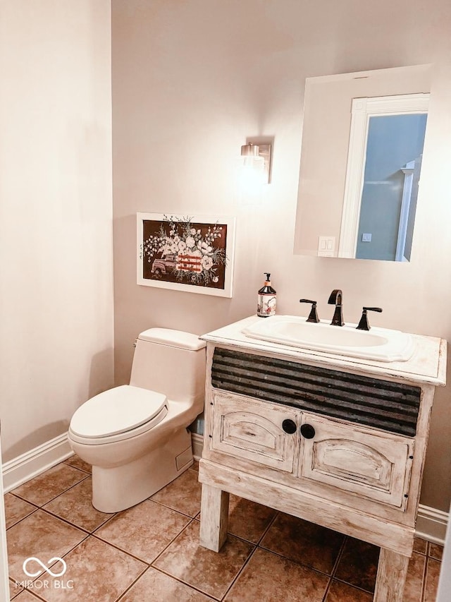 bathroom featuring tile patterned floors, toilet, and vanity