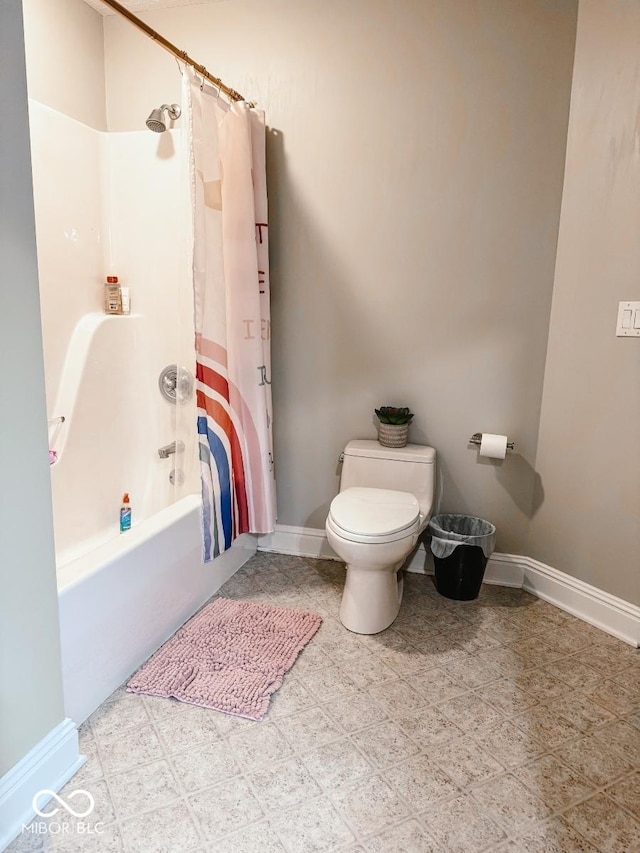 bathroom featuring shower / bathtub combination with curtain and toilet