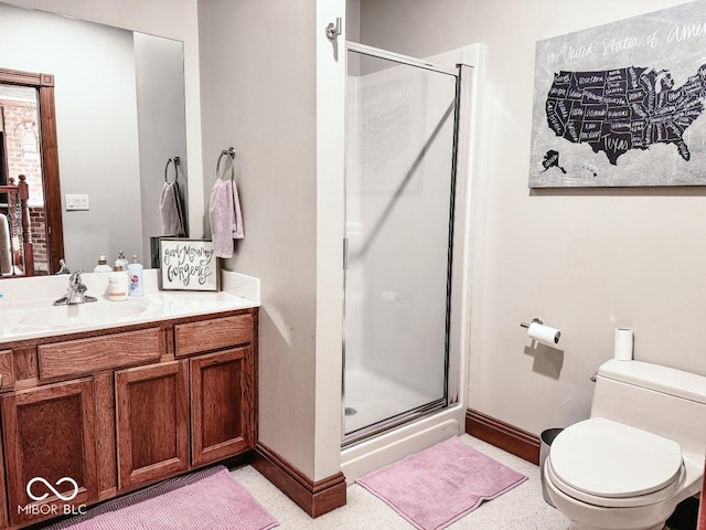 bathroom with vanity, toilet, and a shower with shower door