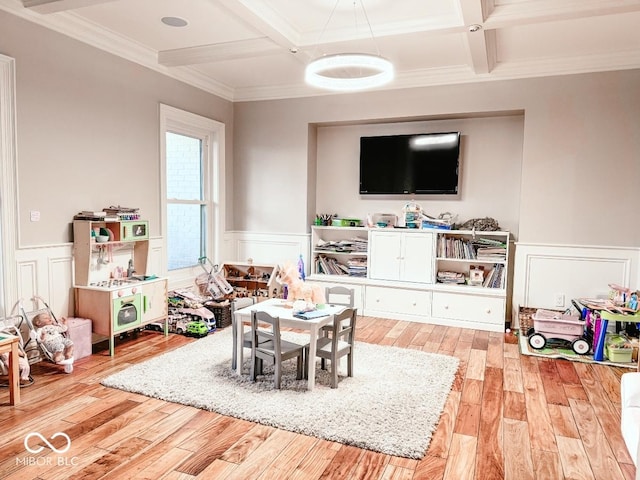 rec room with ornamental molding, coffered ceiling, beam ceiling, and light wood-type flooring