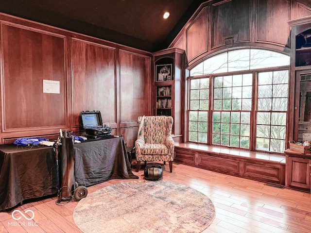 office space featuring lofted ceiling and light hardwood / wood-style floors