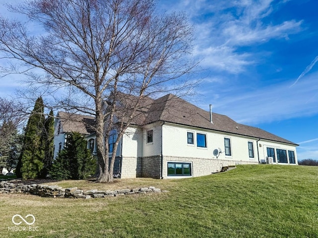 rear view of property with a lawn