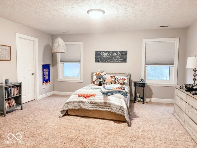 carpeted bedroom with a textured ceiling