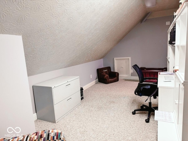 office space featuring vaulted ceiling and a textured ceiling