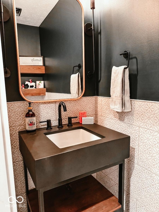 bathroom featuring tasteful backsplash, vanity, and a textured ceiling