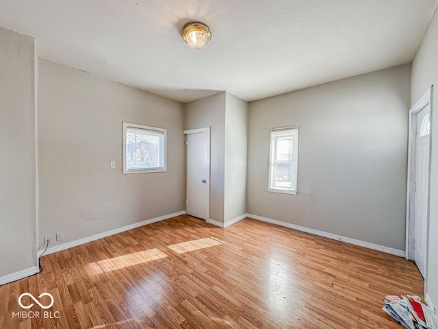 unfurnished bedroom featuring light hardwood / wood-style floors and a textured ceiling