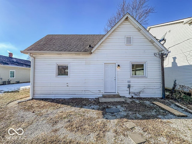 rear view of house featuring central AC unit