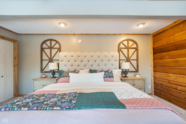 bedroom with crown molding and wooden walls