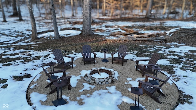 yard covered in snow featuring a fire pit