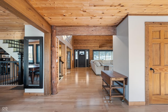 hallway with beam ceiling, wooden walls, wooden ceiling, and light wood-type flooring