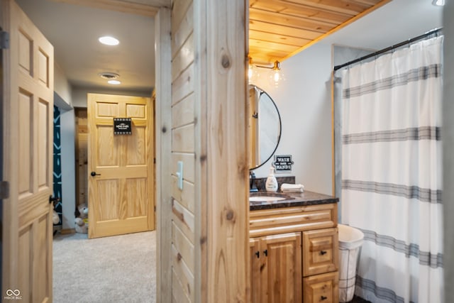 bathroom with wood ceiling and vanity