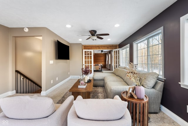 carpeted living room with ceiling fan