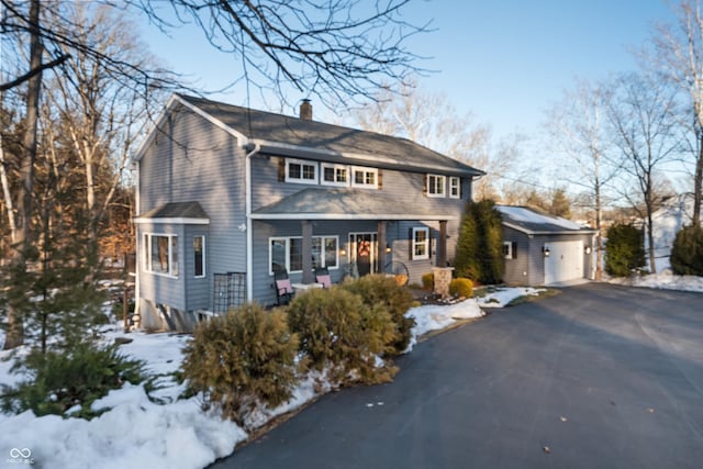 view of property featuring an outbuilding and a garage