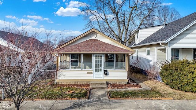 bungalow-style home with a sunroom