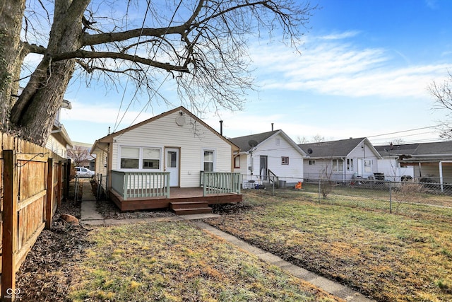 back of house featuring a yard and a deck