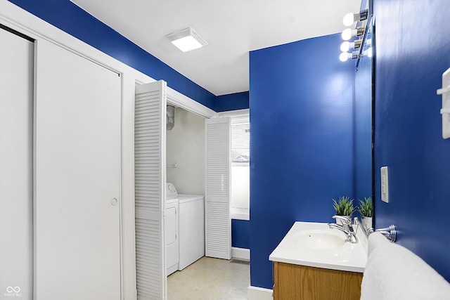 bathroom with vanity and independent washer and dryer