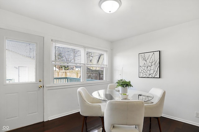 dining space with dark wood-type flooring