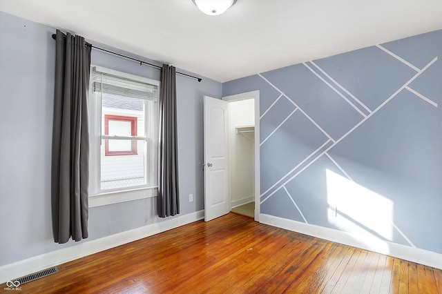 spare room with wood-type flooring