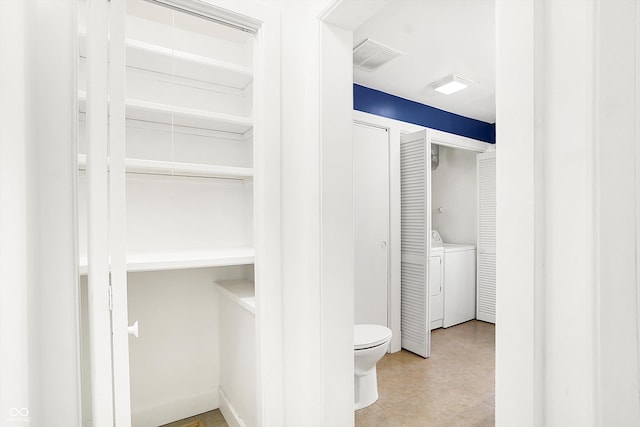 spacious closet featuring washing machine and clothes dryer