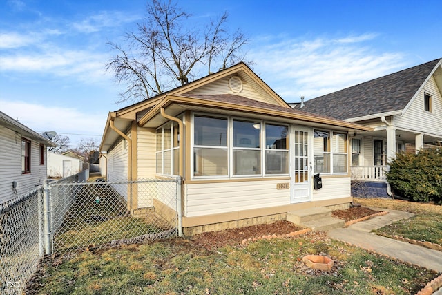 bungalow-style house with a front lawn