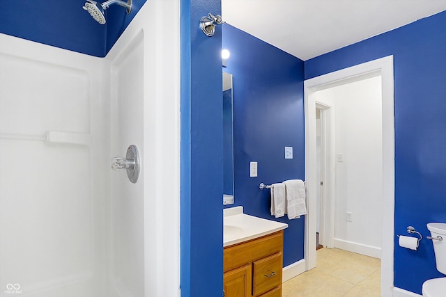 bathroom with tile patterned floors, toilet, vanity, and a shower