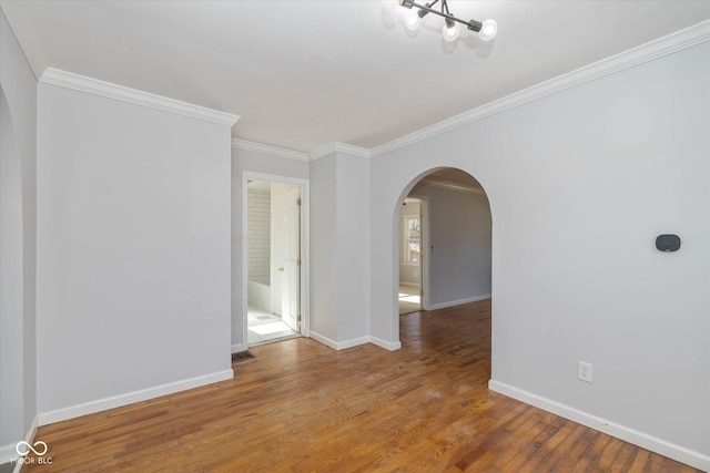 empty room featuring hardwood / wood-style flooring and ornamental molding