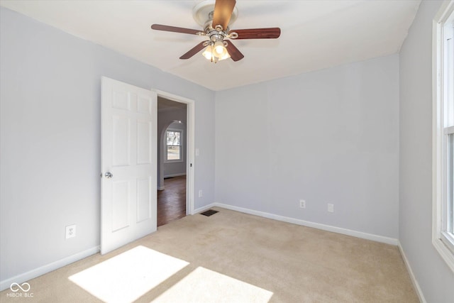 carpeted empty room featuring ceiling fan