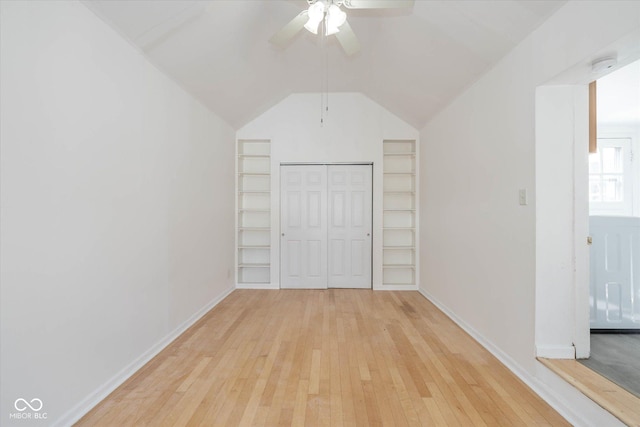 unfurnished bedroom featuring lofted ceiling, a closet, ceiling fan, and light wood-type flooring