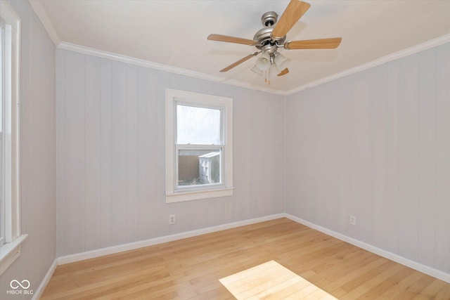 spare room featuring crown molding, ceiling fan, and light wood-type flooring