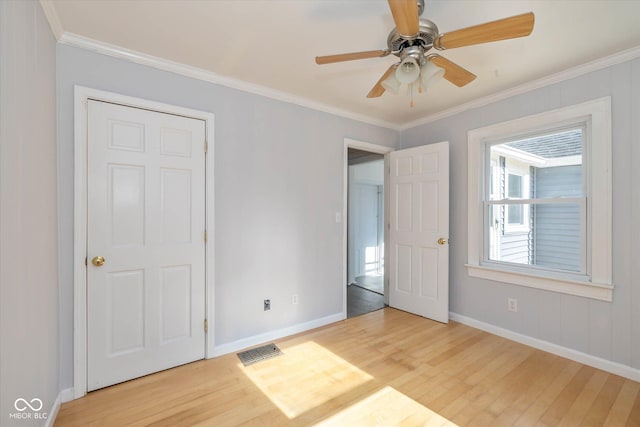 unfurnished bedroom featuring crown molding, ceiling fan, and light wood-type flooring