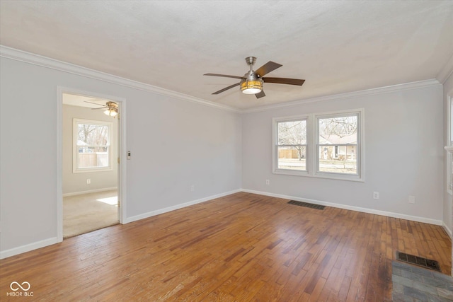 spare room with ceiling fan, crown molding, wood-type flooring, and a textured ceiling