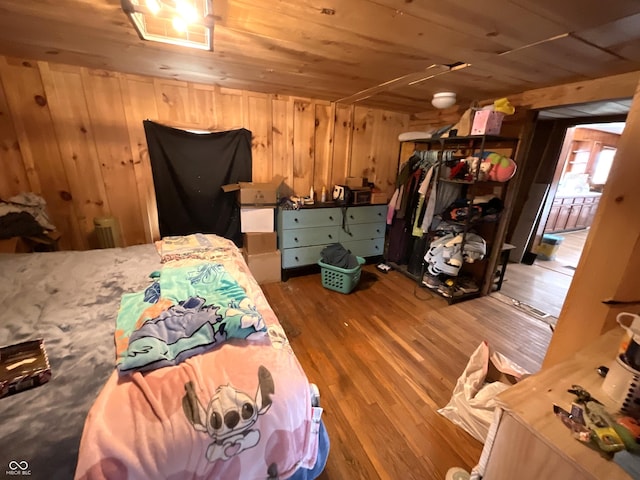 bedroom with wood-type flooring, wooden walls, and wooden ceiling