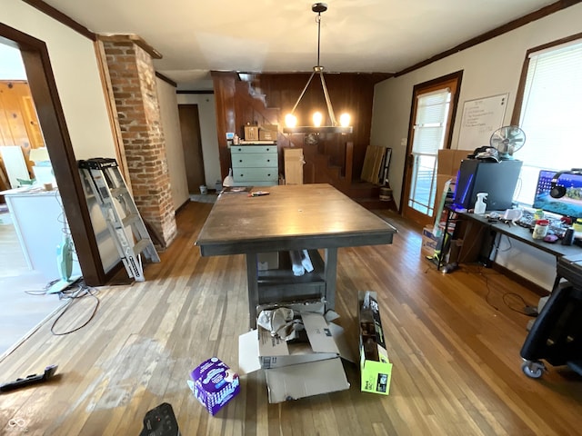 dining area with hardwood / wood-style floors and ornamental molding