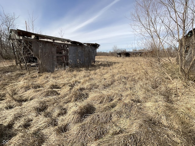 exterior space featuring an outdoor structure and a rural view