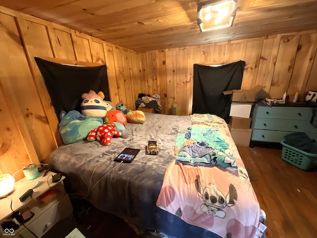 bedroom featuring dark hardwood / wood-style flooring, wooden ceiling, and wood walls