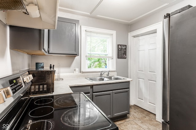 361 S Spencer Ave, Indianapolis, IN 46219 - kitchen featuring stainless steel appliances, gray cabinets, a sink, and light countertops