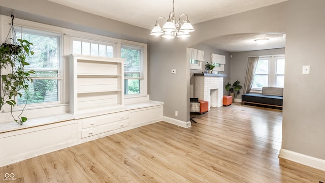 361 S Spencer Ave, Indianapolis, IN 46219 - dining space with arched walkways, light wood-style floors, baseboards, and a chandelier